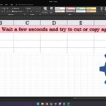 Excel window displaying a message stating "Retrieving data. Wait a few seconds and try to cut or copy again