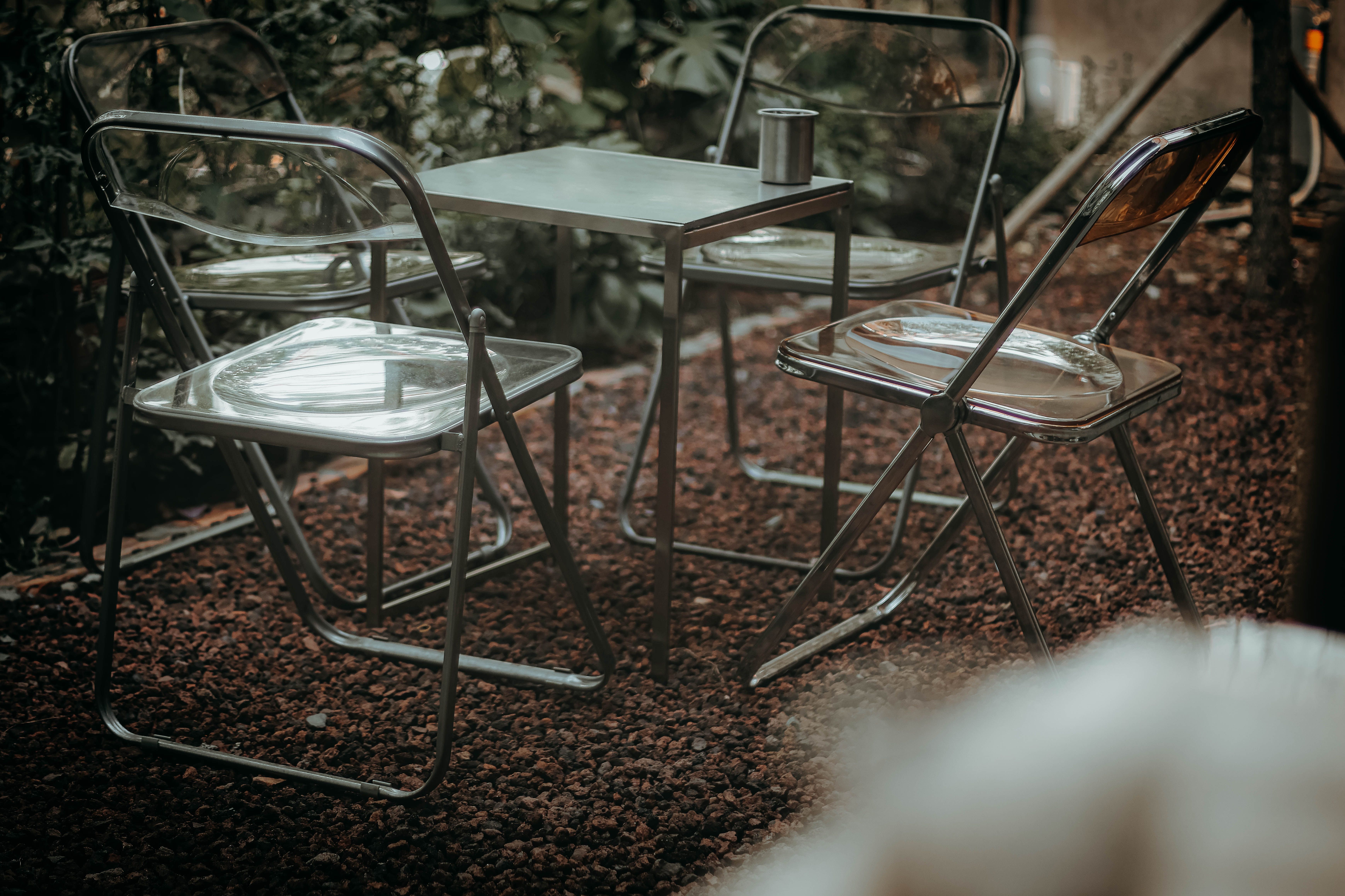 Stylish metal table and chairs arranged in an outdoor garden