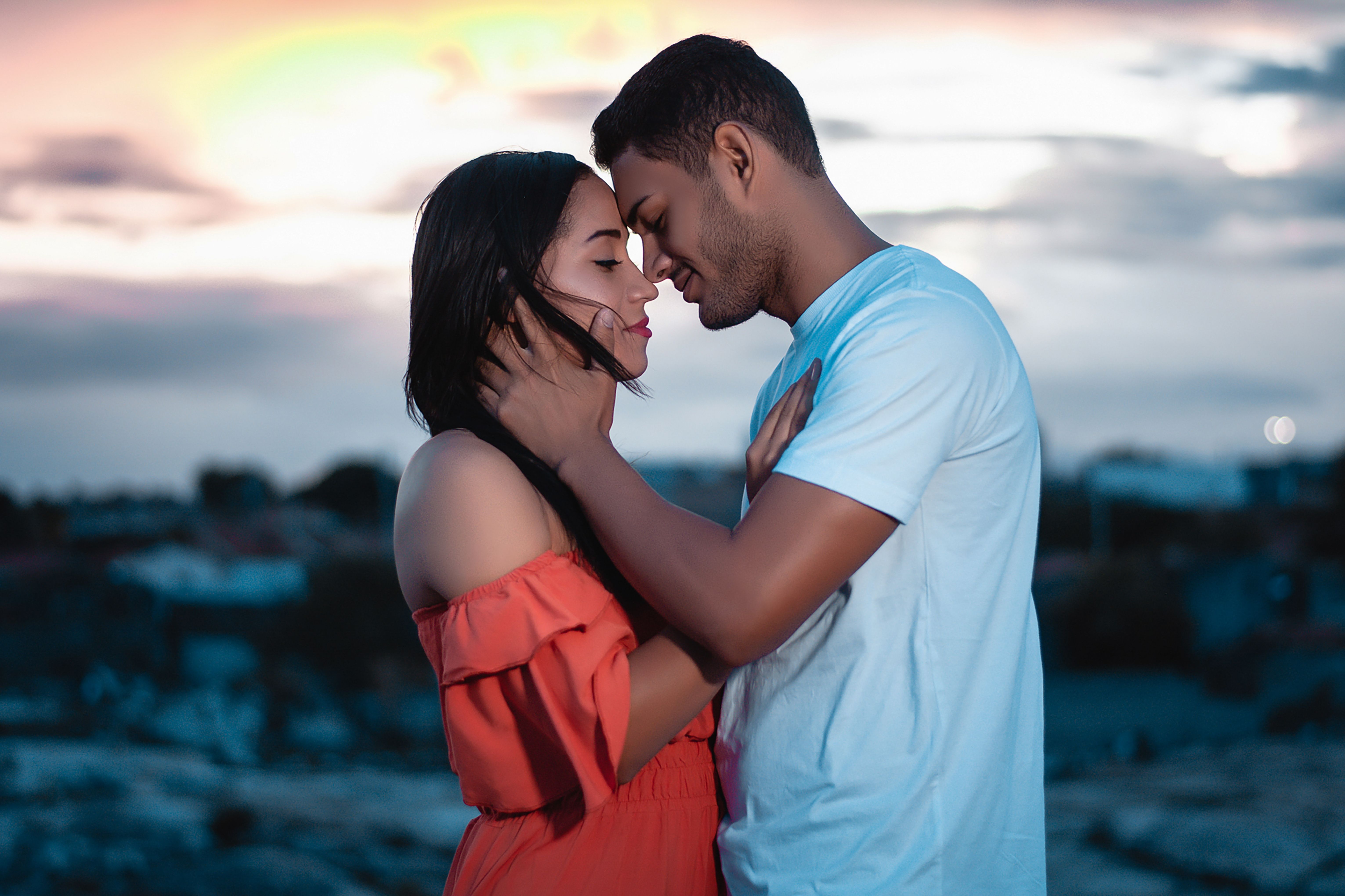 Couple embracing at sunset, illustrating tenderness and emotional intimacy